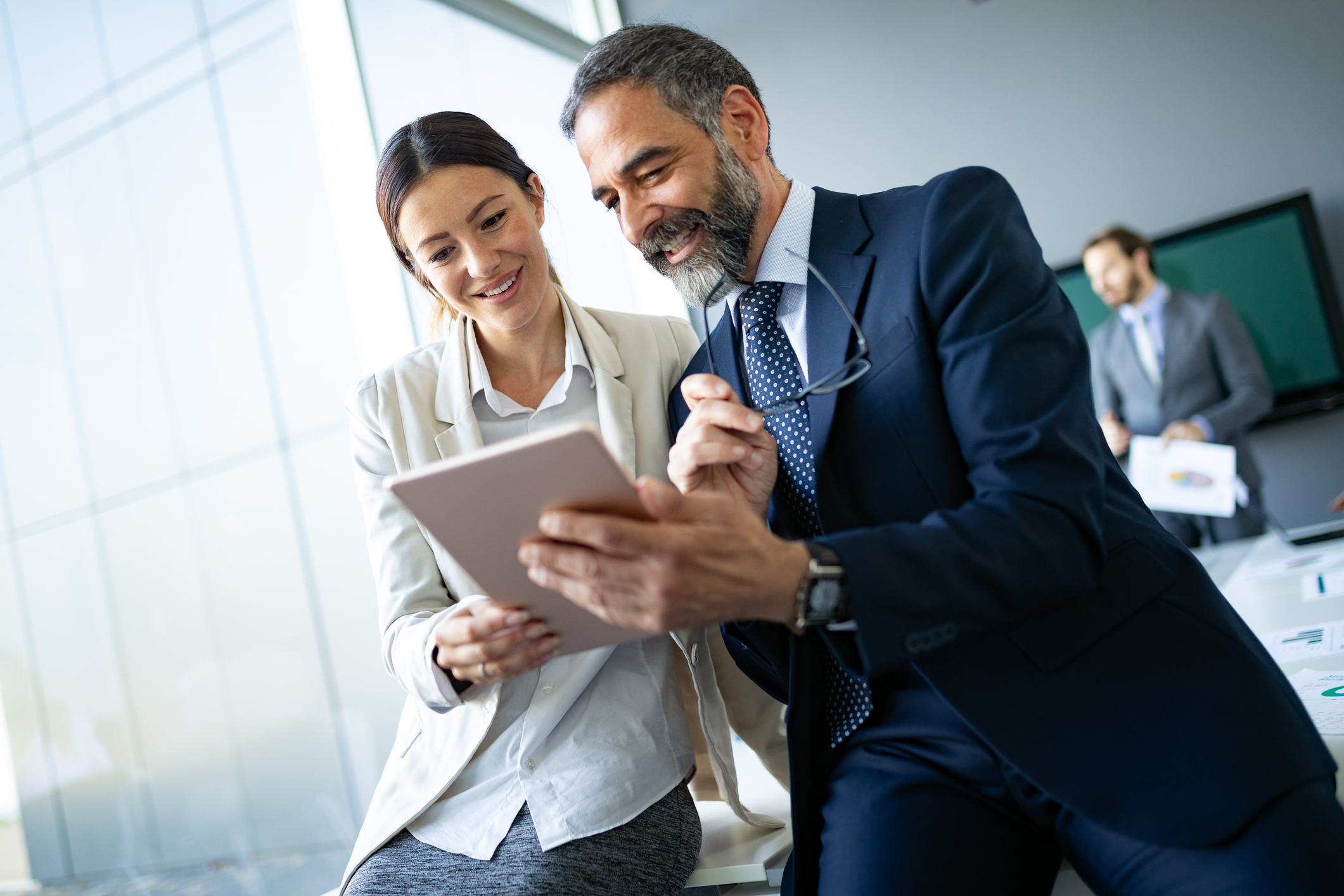 Businesspersons Researching Responsibilities Of Their IT Company